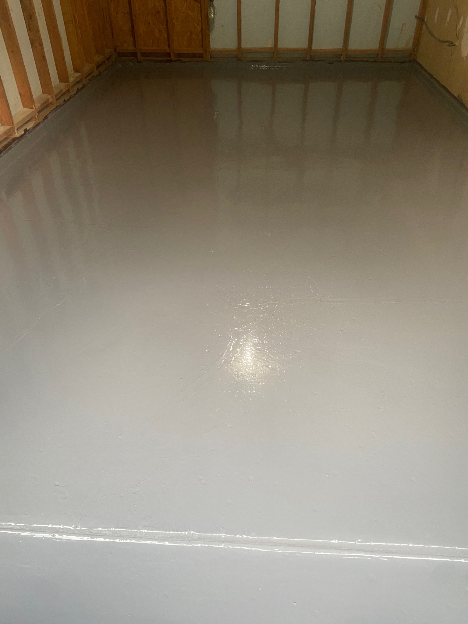 Fresh epoxy floor coating applied to a residential basement in Stafford, VA