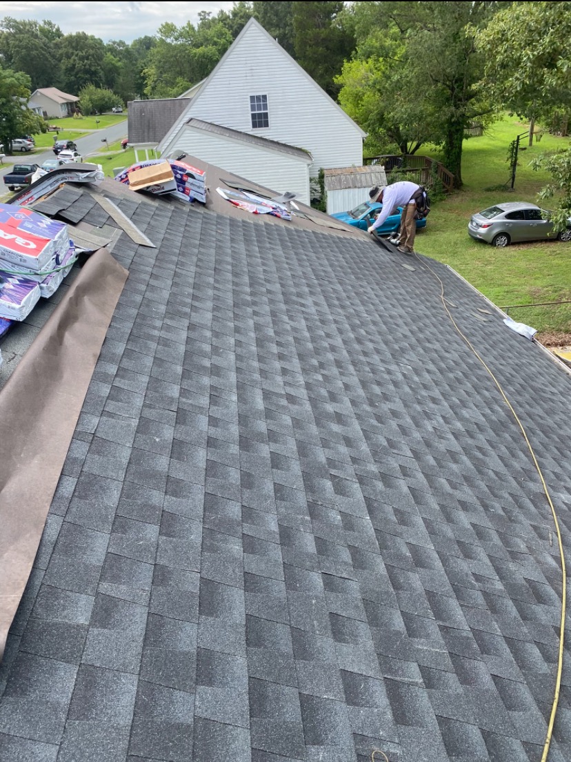 Dre Home Services crew installing shingles on a residential roof in Fredericksburg, VA