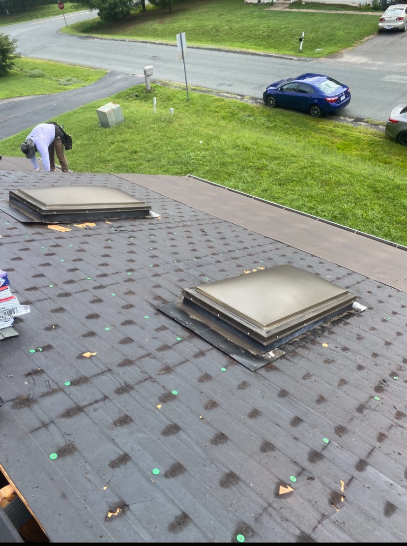 Synthetic roofing underlayment being installed on a flat roof in Culpeper, VA